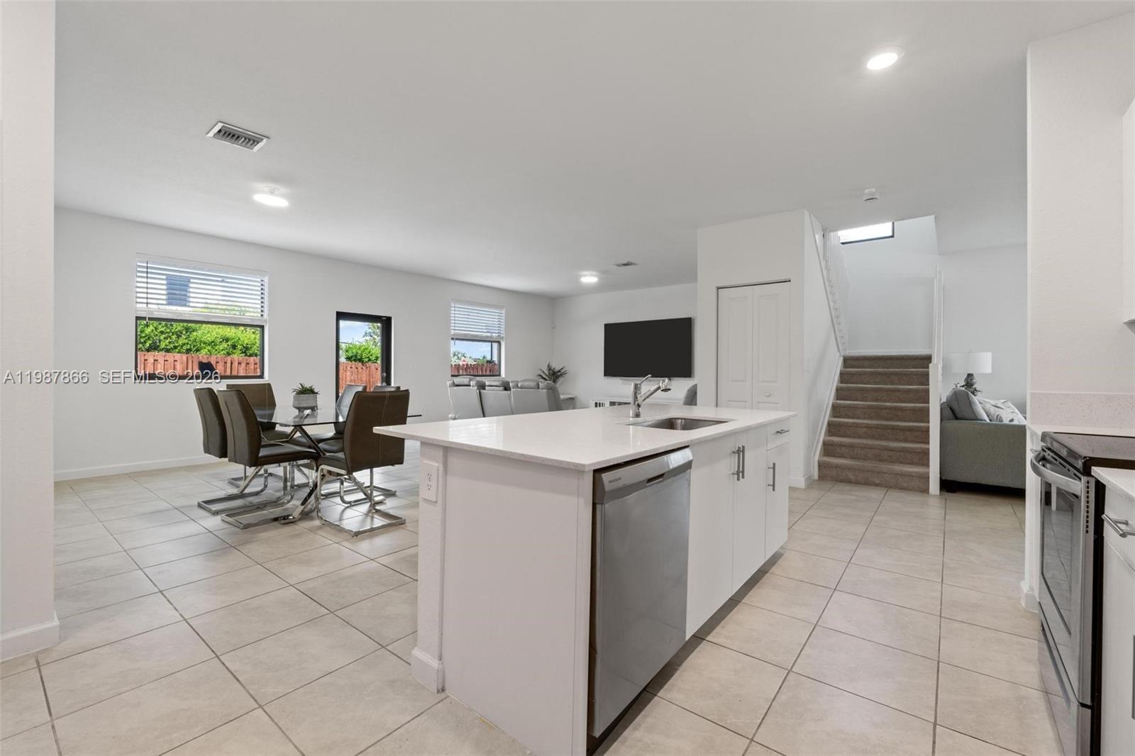 11903 Southwest 241st Street, Unit 11903 Homestead, FL 33032 - Photo 13 of 57 a view of kitchen with counter top appliance and living room
