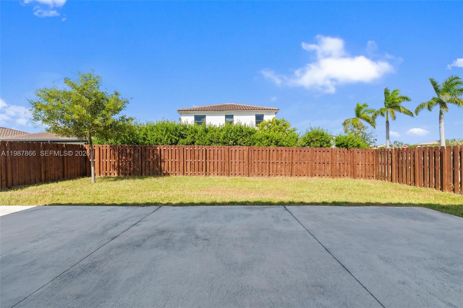 11903 Southwest 241st Street, Unit 11903 Homestead, FL 33032 - Photo 23 of 57 a view of backyard with wooden fence