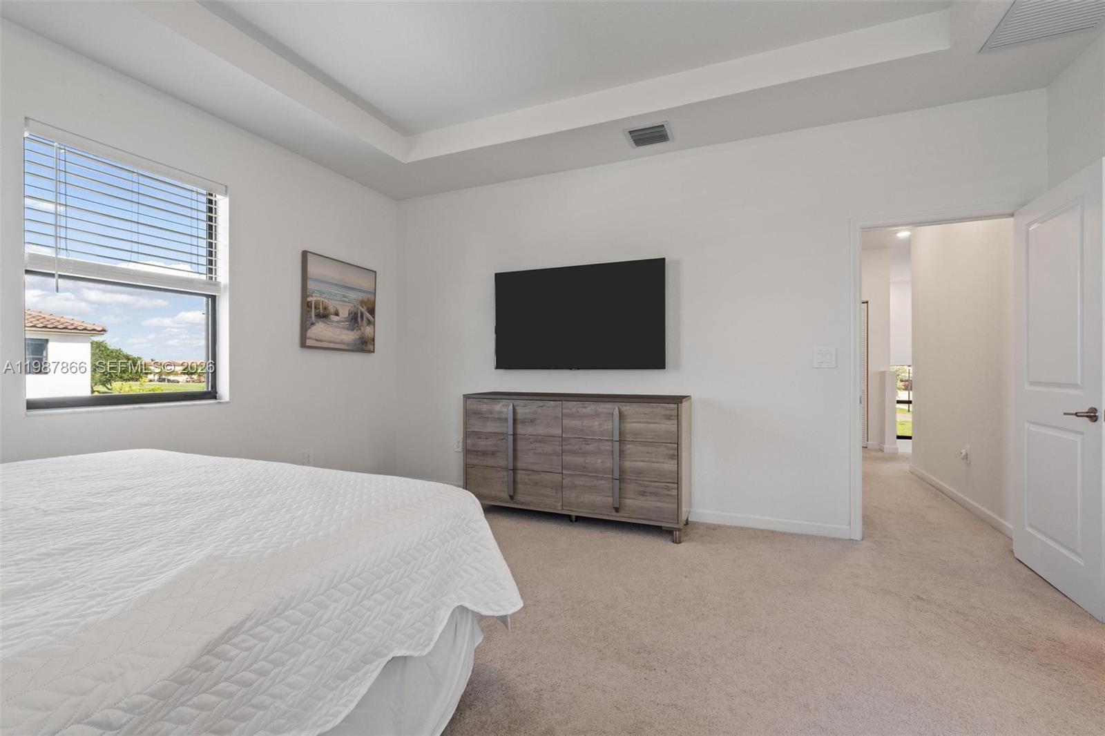 11903 Southwest 241st Street, Unit 11903 Homestead, FL 33032 - Photo 30 of 57 a bedroom with a bed and a flat screen tv