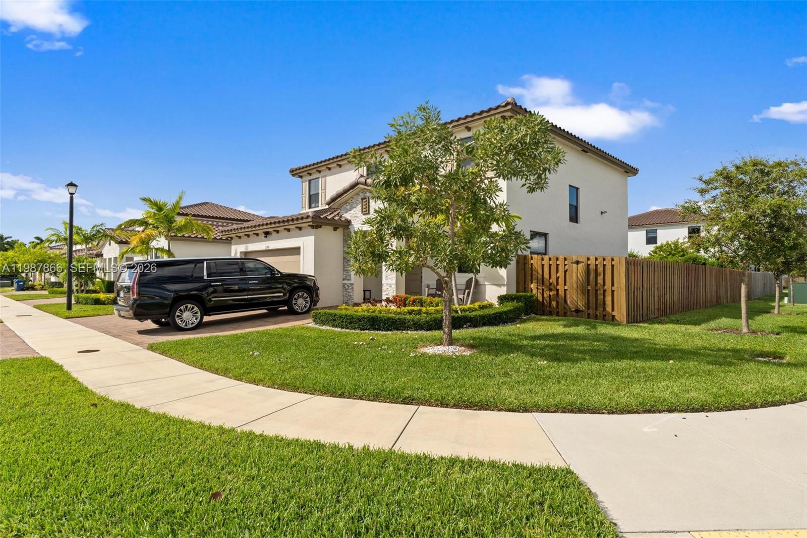 11903 Southwest 241st Street, Unit 11903 Homestead, FL 33032 - Photo 3 of 57 a front view of a house with a garden