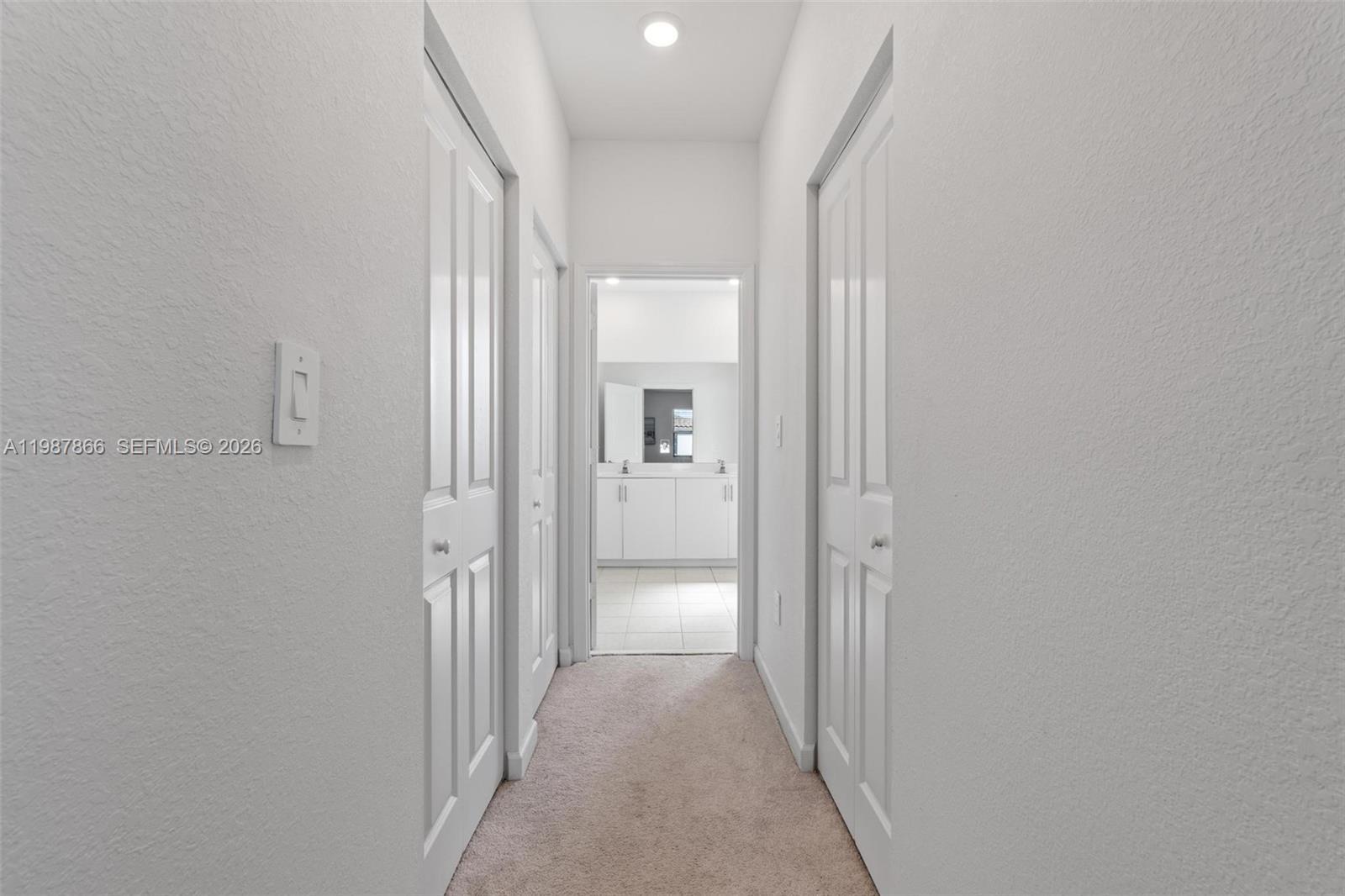 11903 Southwest 241st Street, Unit 11903 Homestead, FL 33032 - Photo 31 of 57 a view of a hallway with wooden floor and a bathroom