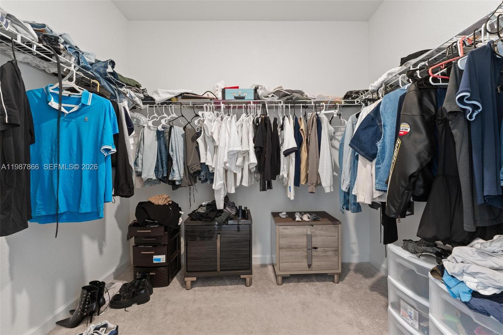 11903 Southwest 241st Street, Unit 11903 Homestead, FL 33032 - Photo 32 of 57 a view of walk in closet with clothes and shoes