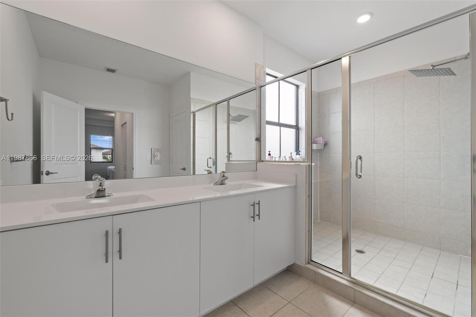 11903 Southwest 241st Street, Unit 11903 Homestead, FL 33032 - Photo 34 of 57 a bathroom with a shower sink and mirror
