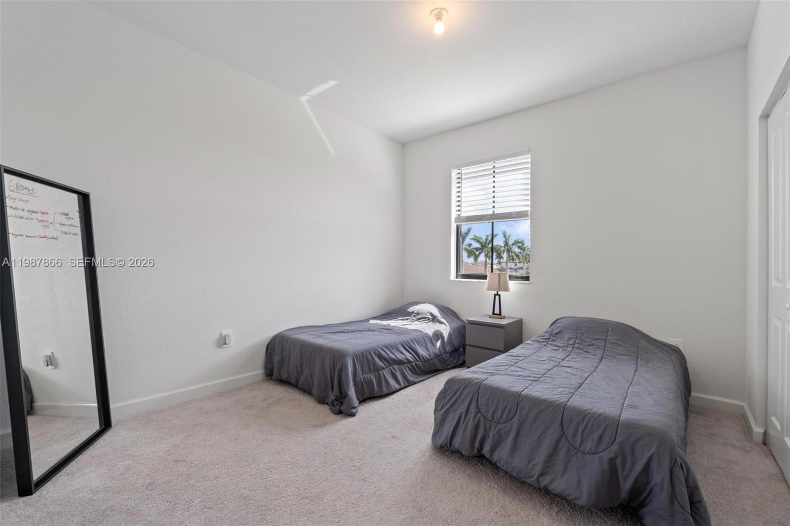 11903 Southwest 241st Street, Unit 11903 Homestead, FL 33032 - Photo 36 of 57 a bedroom with two beds and a window