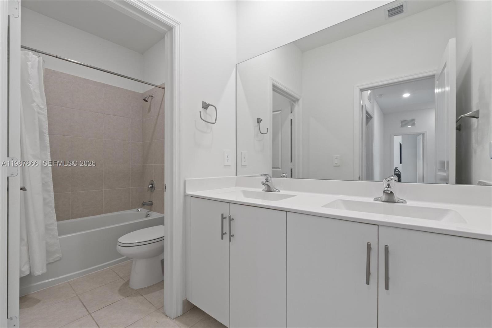 11903 Southwest 241st Street, Unit 11903 Homestead, FL 33032 - Photo 38 of 57 a bathroom with a double vanity sink toilet and shower