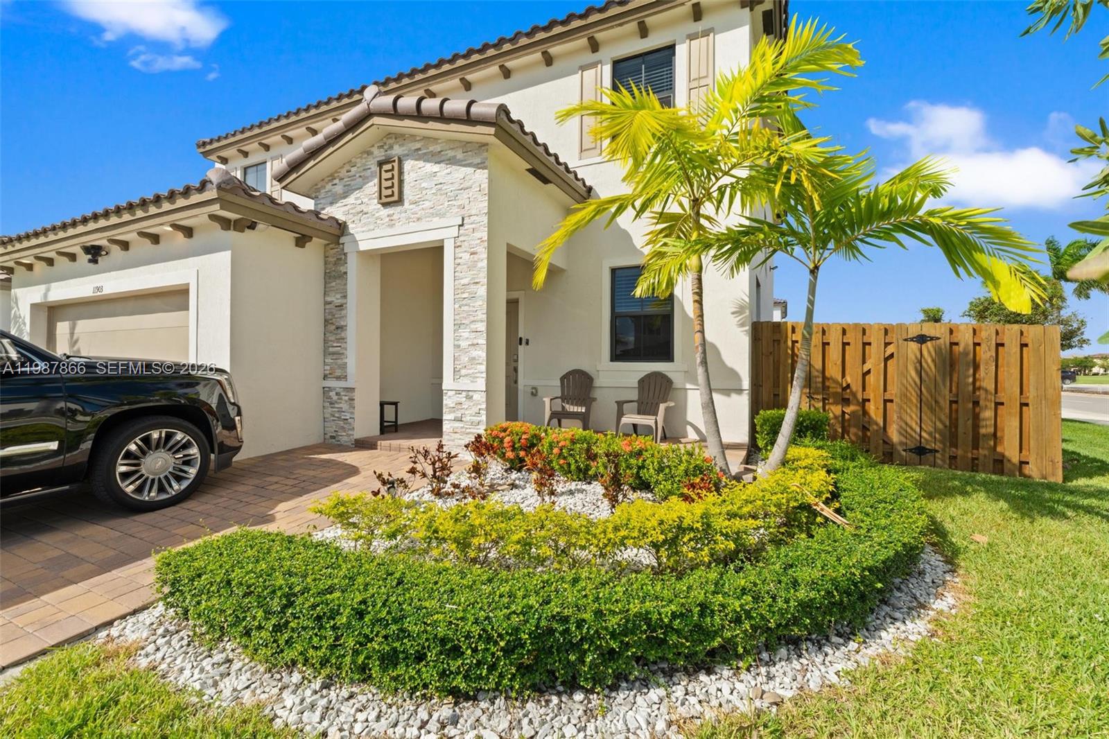 11903 Southwest 241st Street, Unit 11903 Homestead, FL 33032 - Photo 4 of 57 a front view of a house with a garden