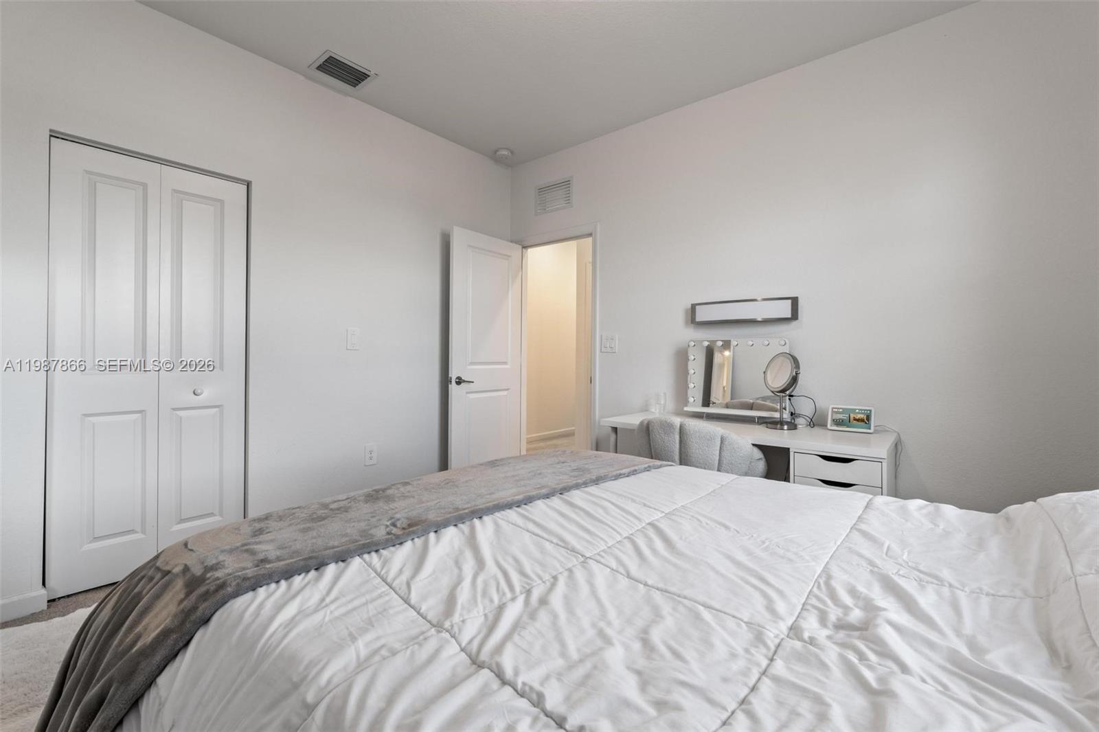 11903 Southwest 241st Street, Unit 11903 Homestead, FL 33032 - Photo 43 of 57 a bedroom with a bed and a closet