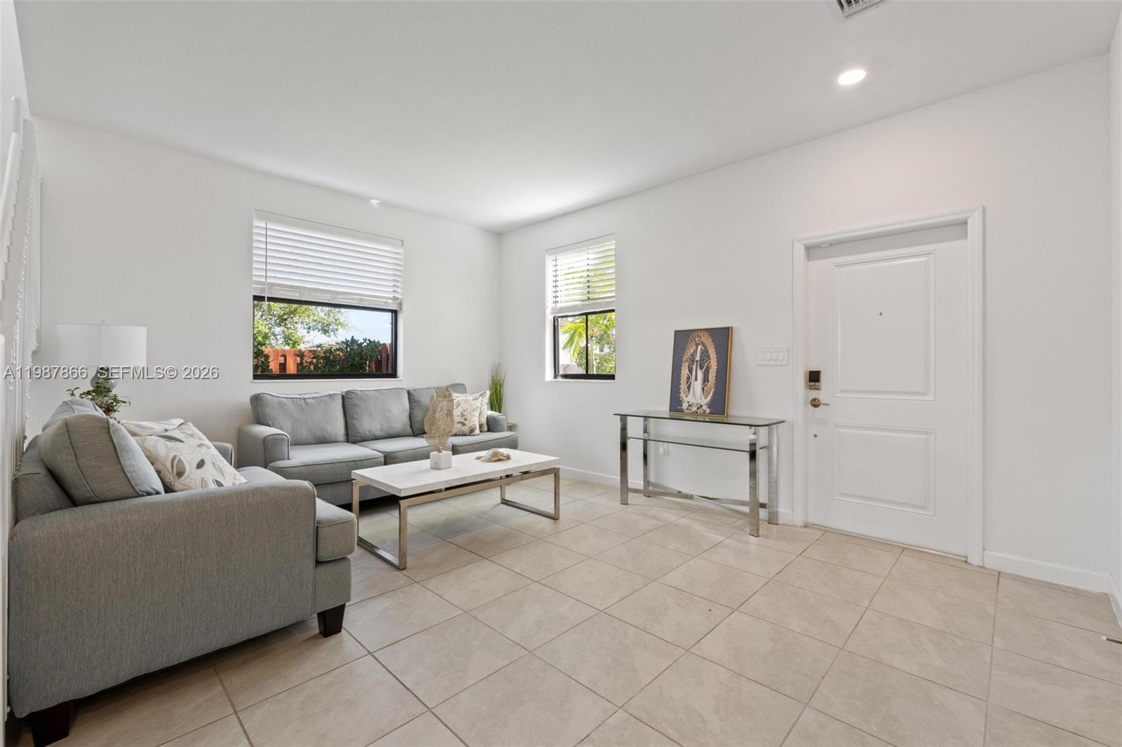 11903 Southwest 241st Street, Unit 11903 Homestead, FL 33032 - Photo 7 of 57 a living room with furniture and window