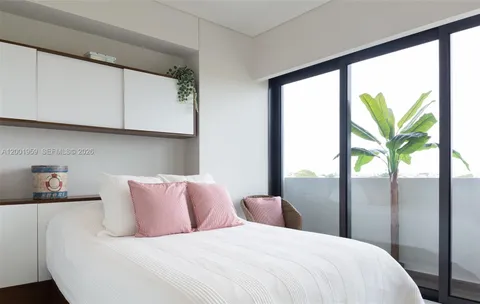 a bedroom with a large bed and a window