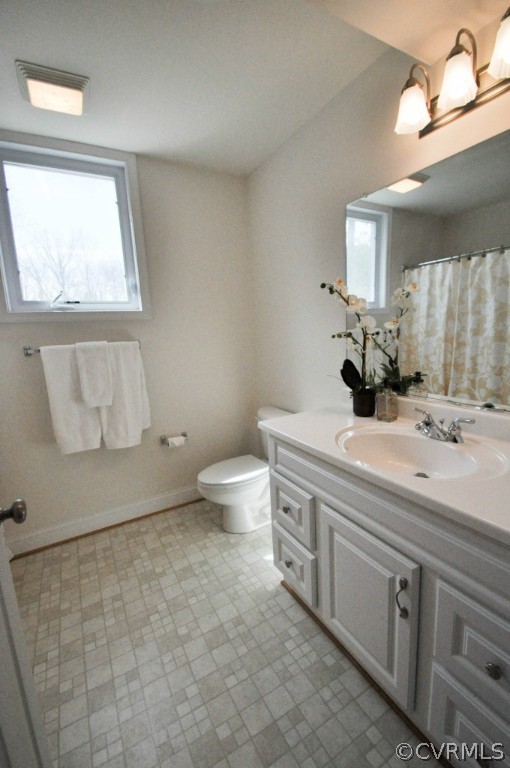 20348 Ben Gayle Road Beaverdam, VA 23015 - Photo 16 of 24 a bathroom with a double vanity sink toilet and a mirror