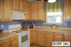 3208 Lentel Road Midland, NC 28107 - Photo 5 of 8 a kitchen with granite countertop cabinets stainless steel appliances a sink and a window