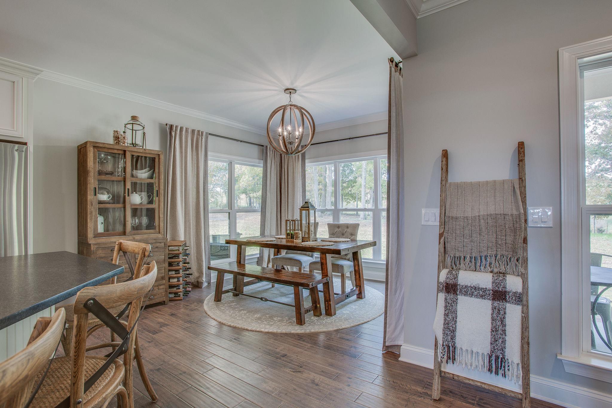7901 Pinewood Road Fairview, TN 37062 - Photo 10 of 29 a view of a dining room with furniture window and wooden floor