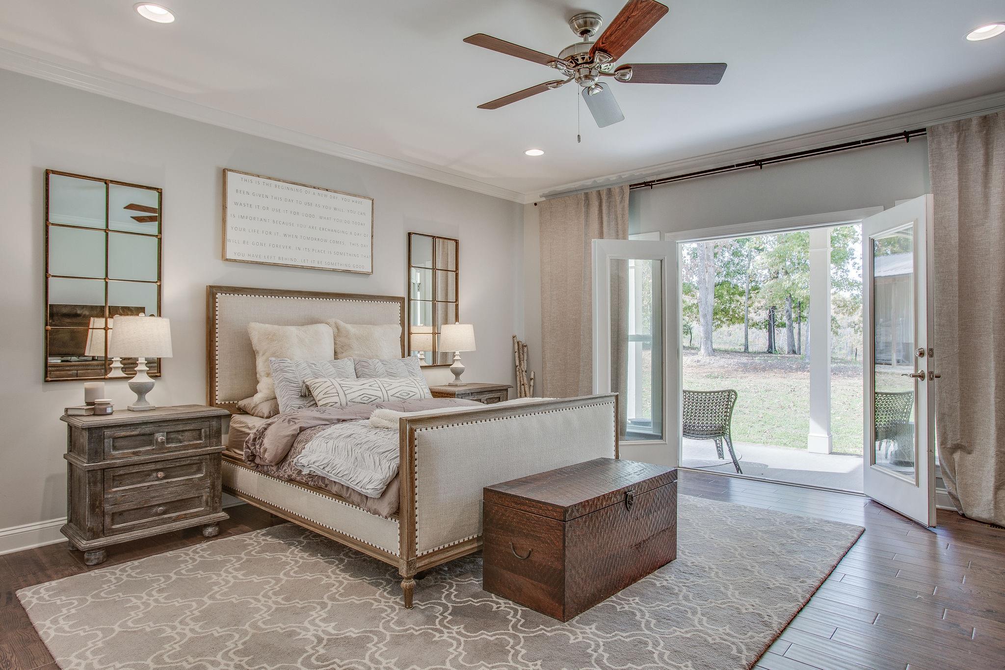 7901 Pinewood Road Fairview, TN 37062 - Photo 15 of 29 a spacious bedroom with a large bed and a chandelier