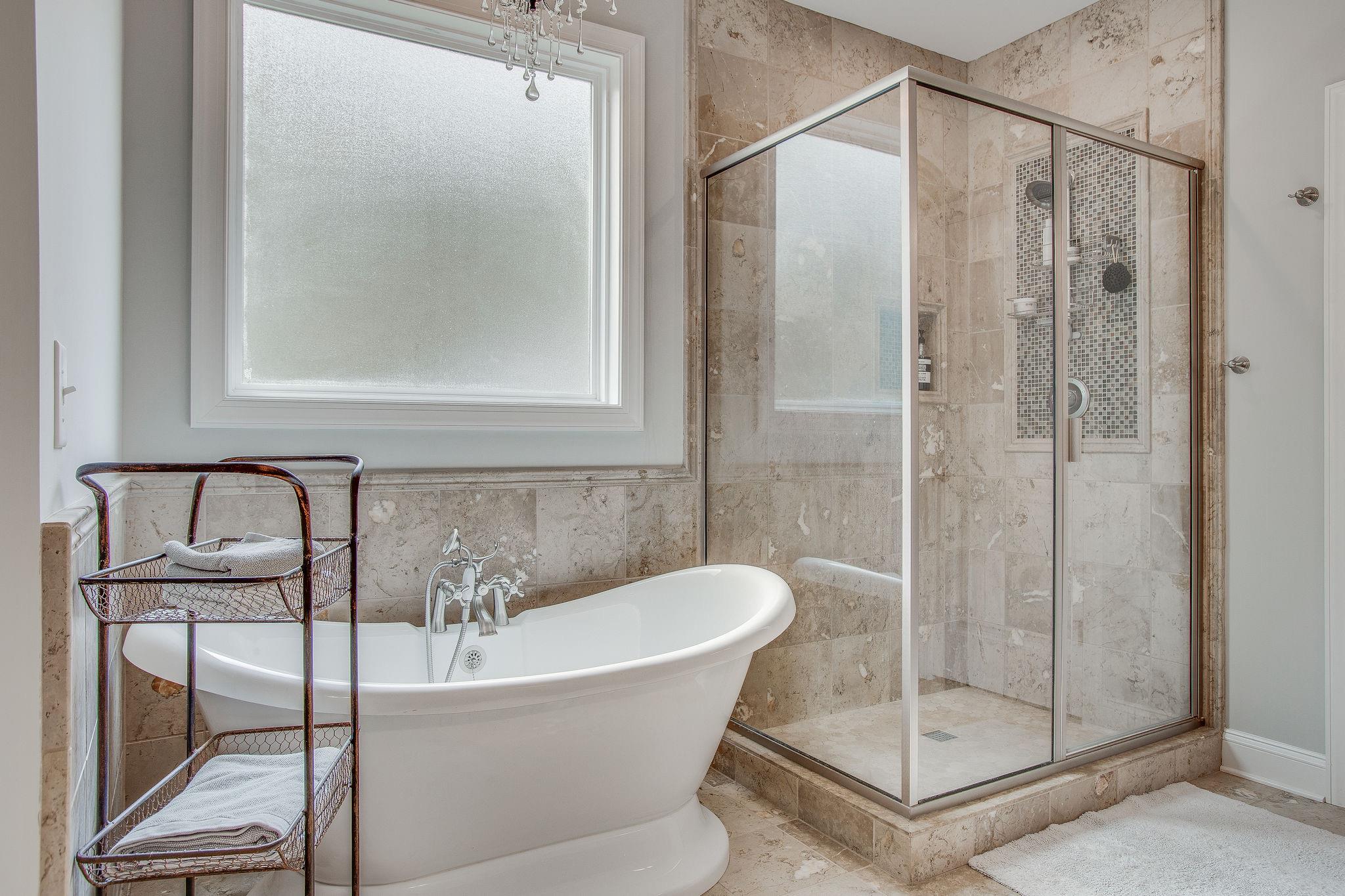 7901 Pinewood Road Fairview, TN 37062 - Photo 17 of 29 a bathroom with a bathtub and shower