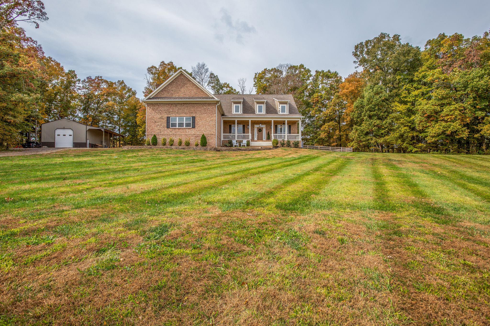 7901 Pinewood Road Fairview, TN 37062 - Photo 2 of 29 a view of a house with a big yard and large trees