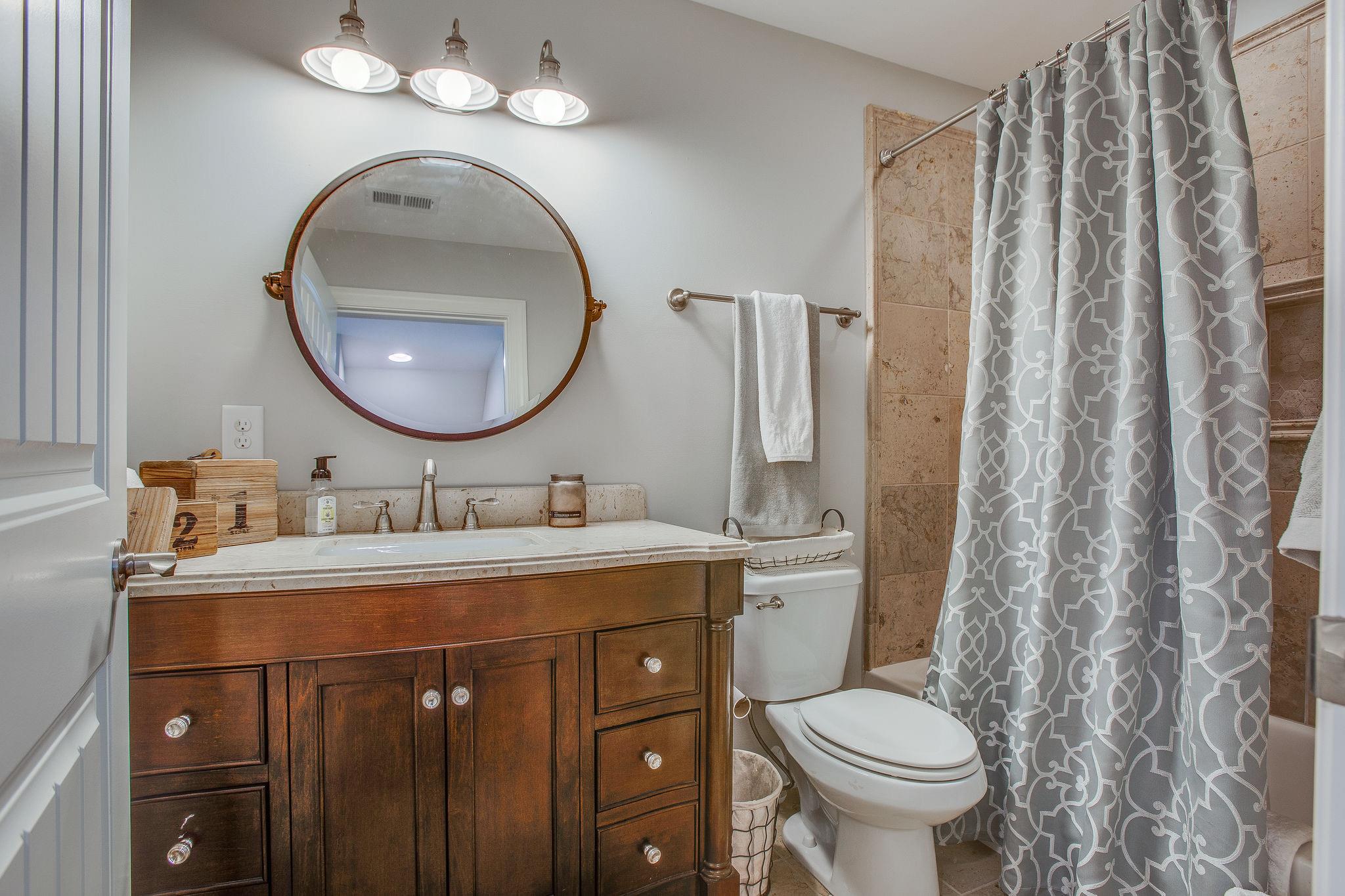 7901 Pinewood Road Fairview, TN 37062 - Photo 23 of 29 a bathroom with a toilet sink and mirror