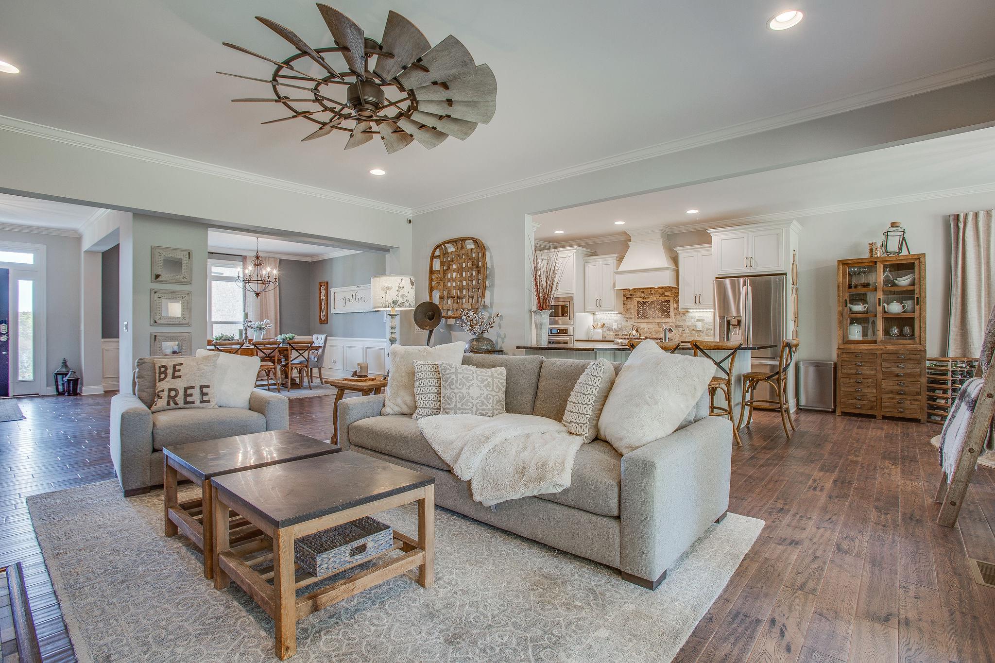 7901 Pinewood Road Fairview, TN 37062 - Photo 29 of 29 a living room with furniture a dining table and a chandelier