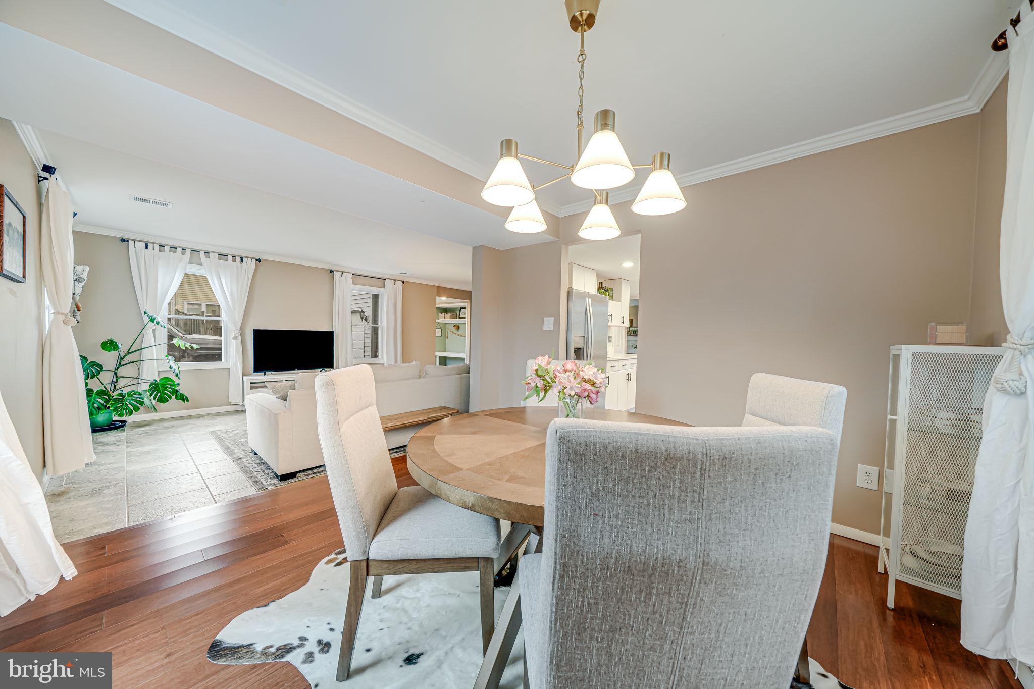 116 Elm Tree Lane Sterling, VA 20164 - Photo 12 of 56 a view of a dining room with furniture wooden floor and chandelier