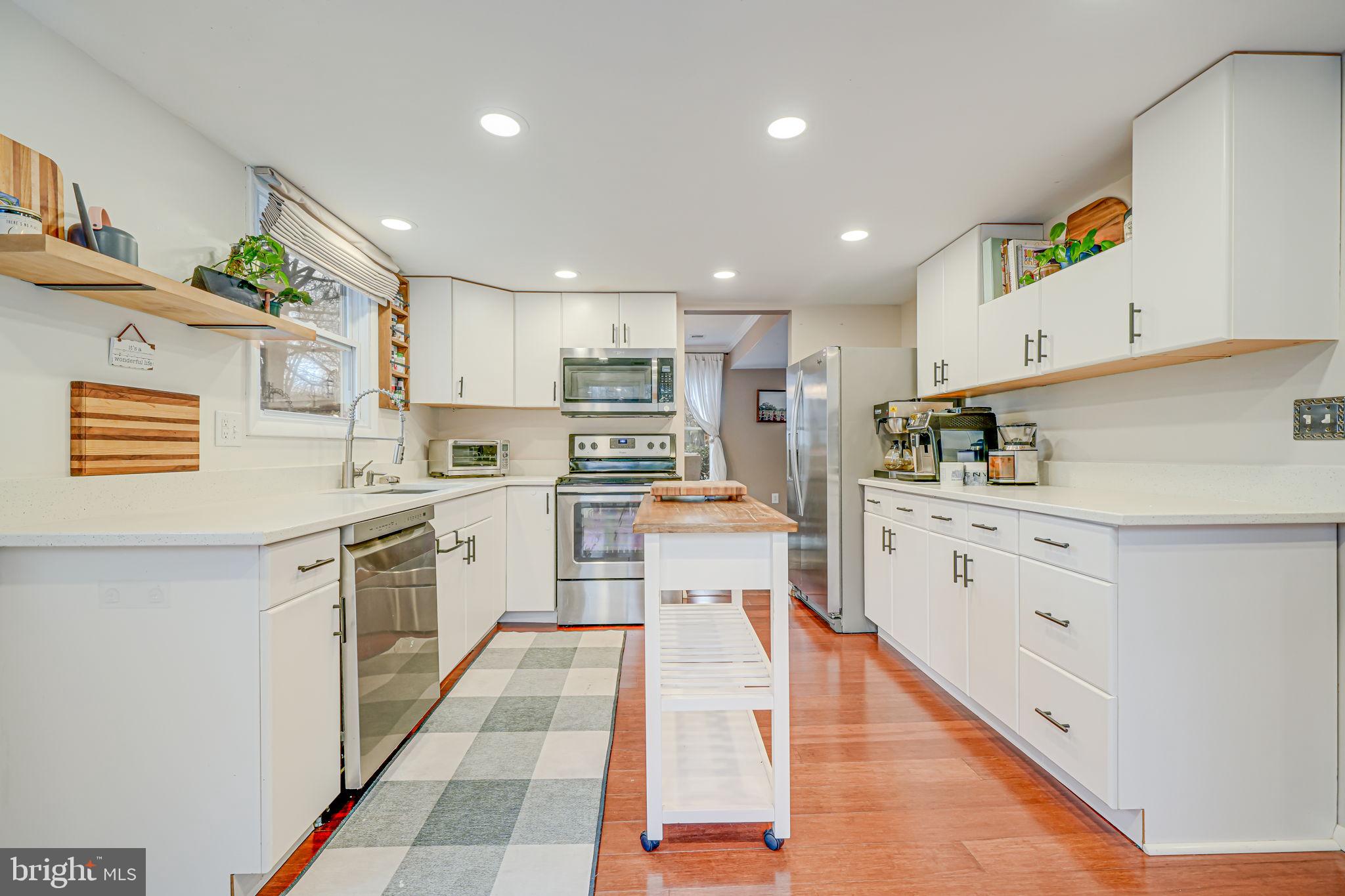 116 Elm Tree Lane Sterling, VA 20164 - Photo 15 of 56 a large kitchen with stainless steel appliances kitchen island granite countertop a sink and cabinets