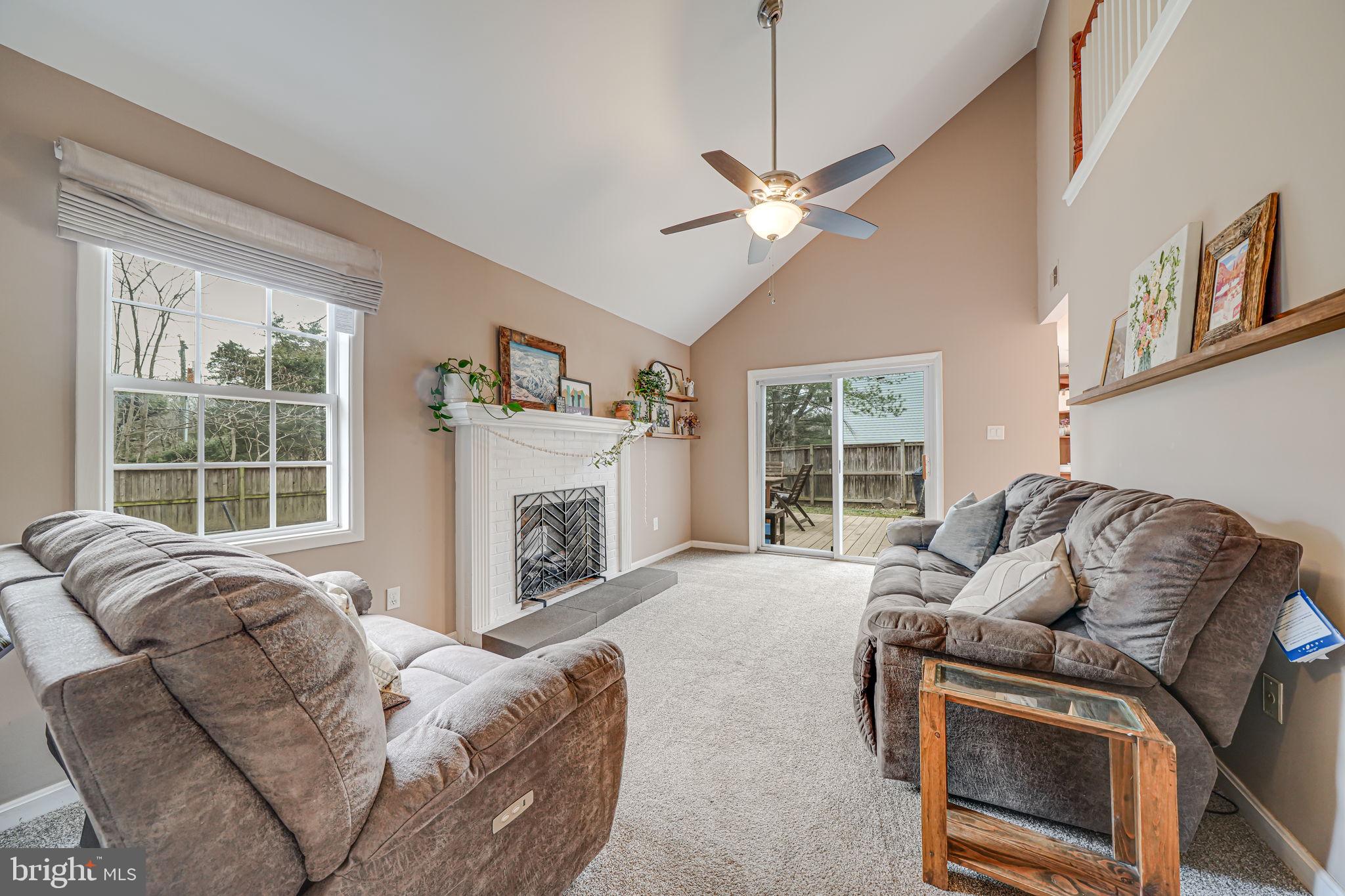 116 Elm Tree Lane Sterling, VA 20164 - Photo 21 of 56 a living room with furniture a fireplace and a large window