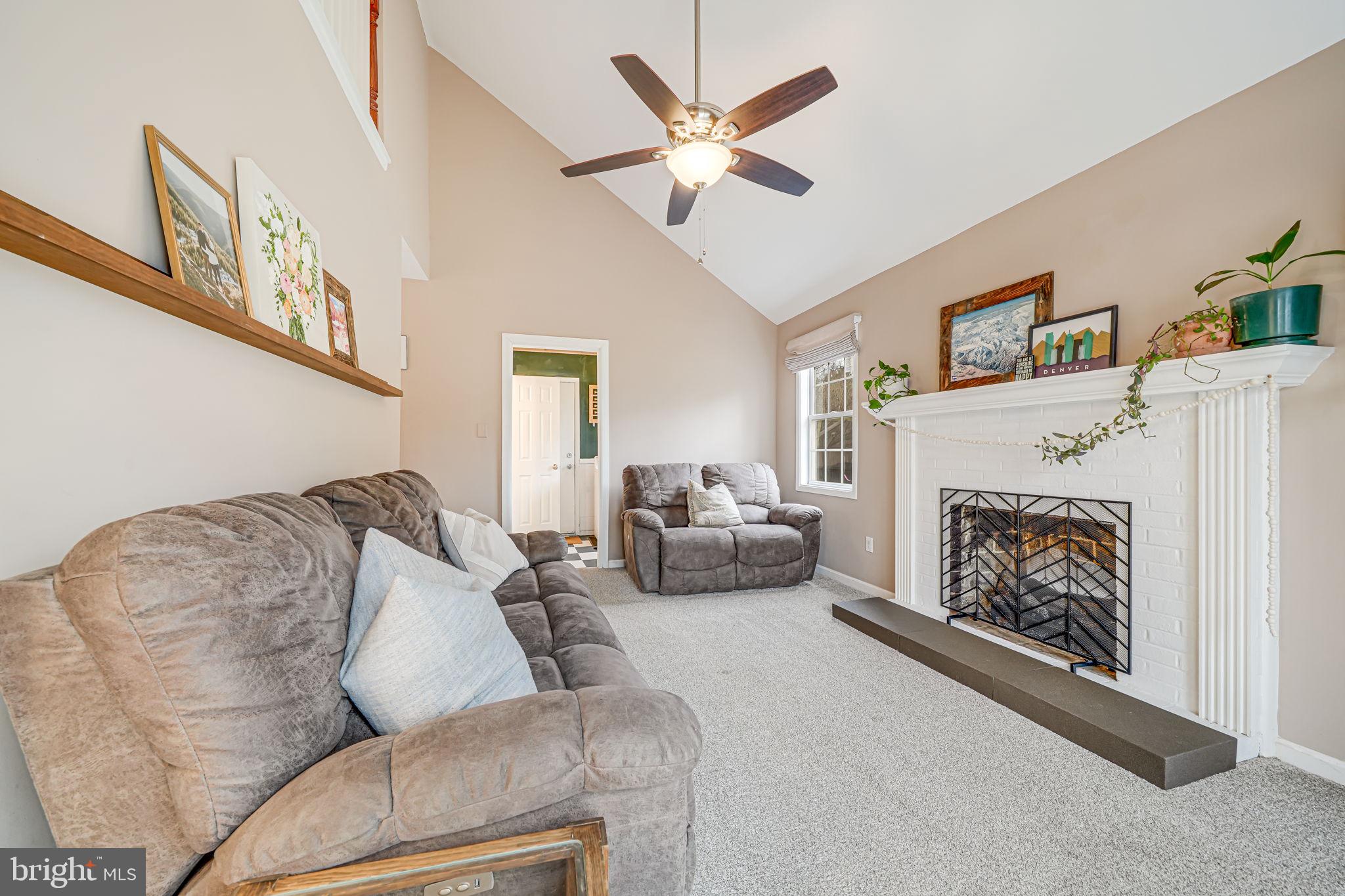 116 Elm Tree Lane Sterling, VA 20164 - Photo 23 of 56 a living room with furniture a fireplace and a ceiling fan