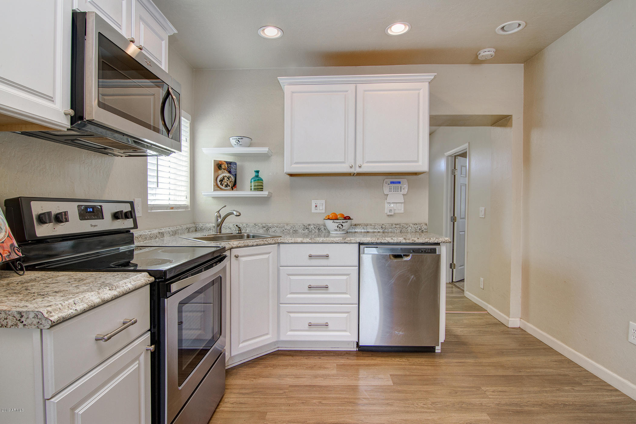 1124 West Mountain View Road Phoenix, AZ 85021 - Photo 8 of 25 a kitchen with stainless steel appliances granite countertop a stove a sink and a refrigerator