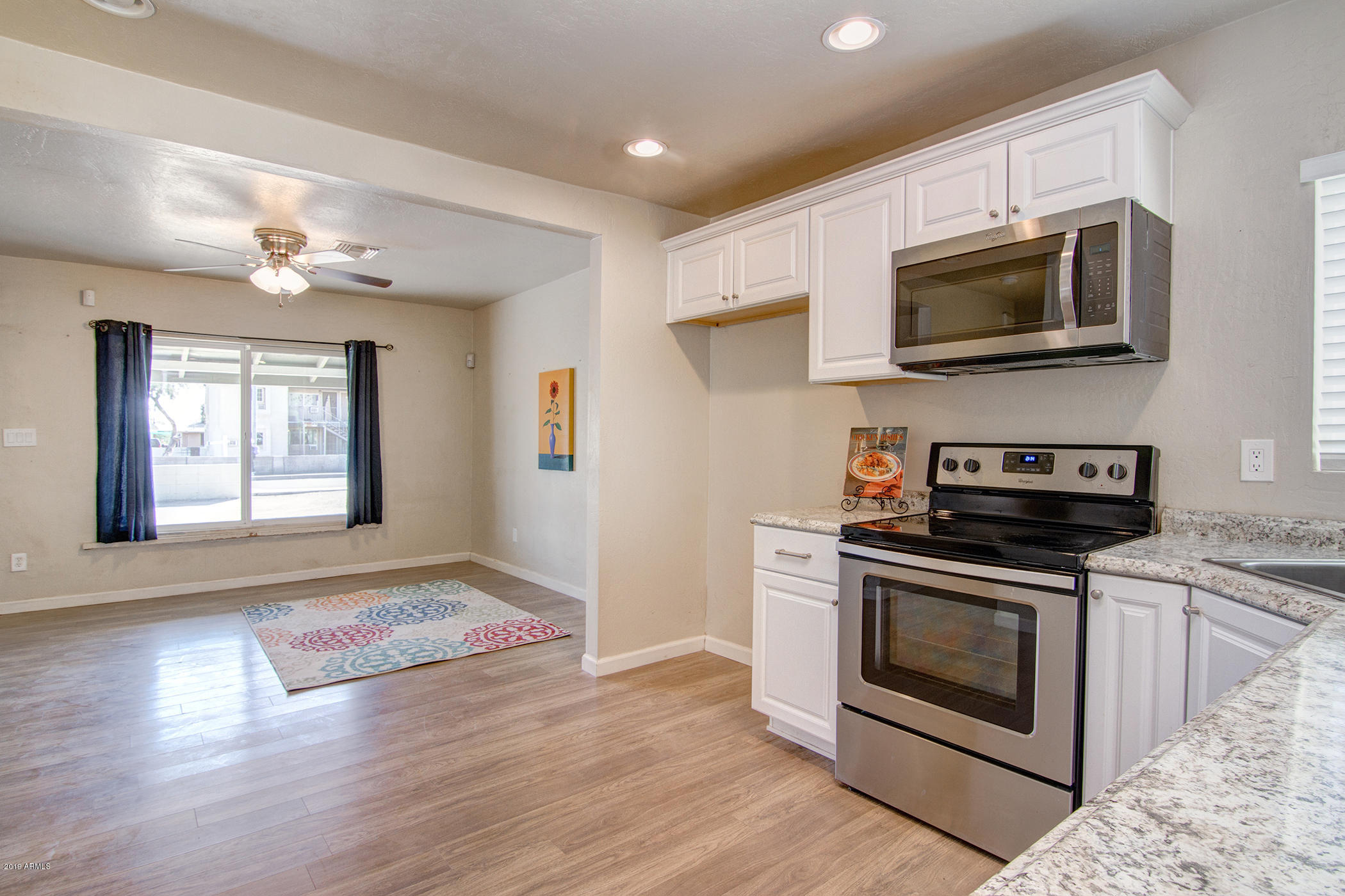 1124 West Mountain View Road Phoenix, AZ 85021 - Photo 9 of 25 a kitchen with stainless steel appliances a stove a microwave and sink