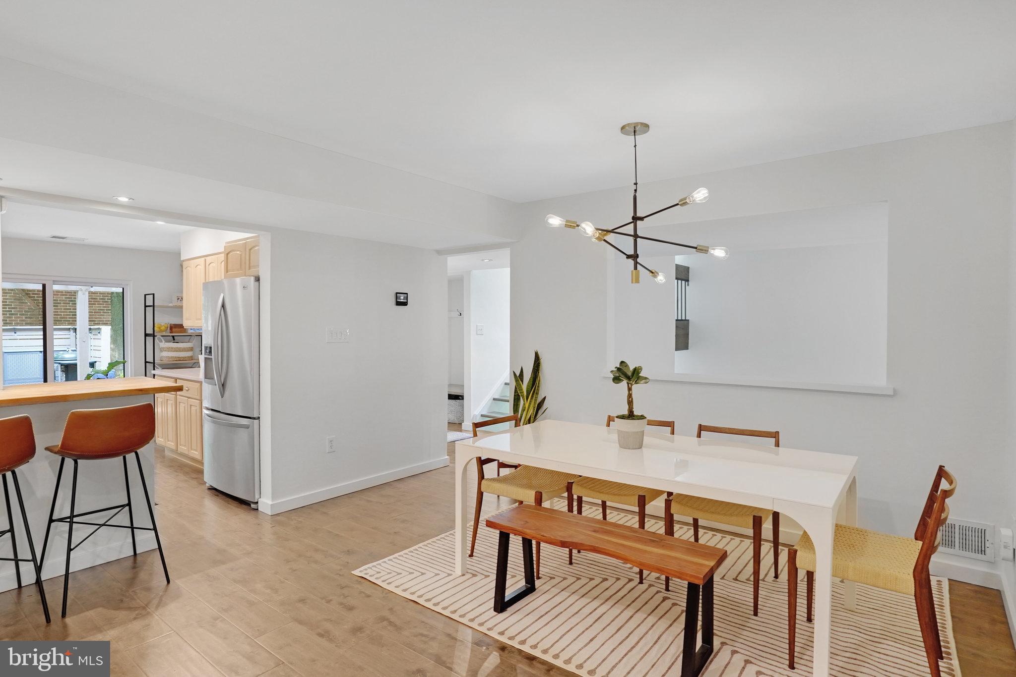 11784 Indian Ridge Road Reston, VA 20191 - Photo 11 of 44 a dining room with furniture a window and a chandelier