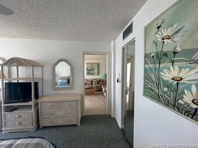 a bedroom with a bed and a lamp