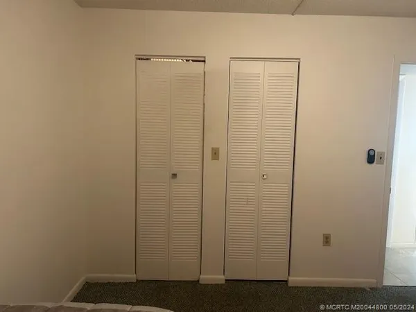 a bathroom with a granite countertop sink a light fixture and a mirror