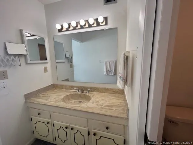 a white toilet sitting next to a shower