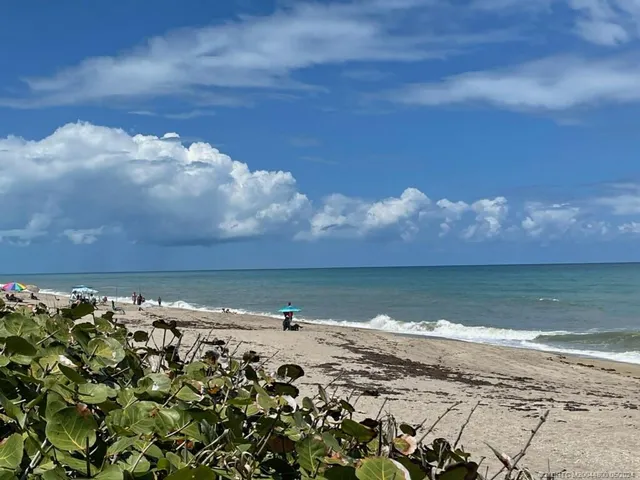 a view of a swimming pool with chairs in patio
