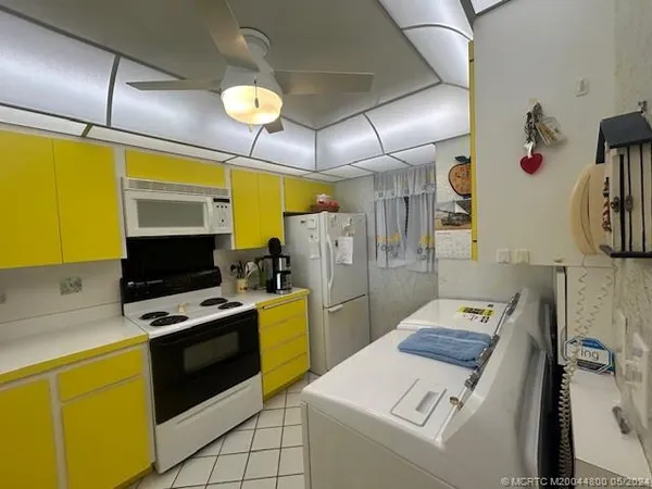 a kitchen with stainless steel appliances a stove a sink and a microwave