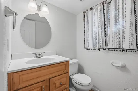 a bathroom with a sink a toilet and mirror