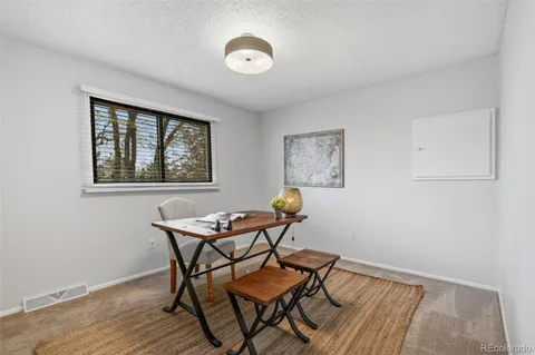 a dining room with furniture and window