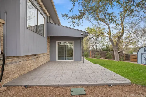 a view of a house with backyard and tree s