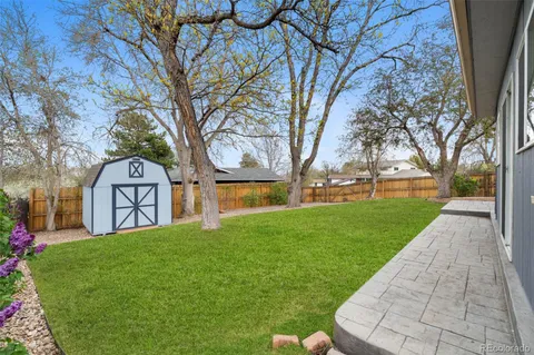 a view of a house with a yard and sitting area