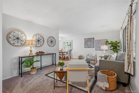 a living room with furniture a clock and a window