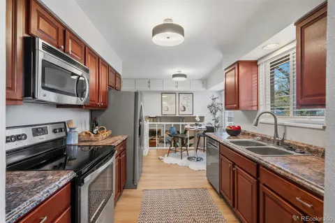 a kitchen with stainless steel appliances granite countertop a stove sink microwave and cabinets