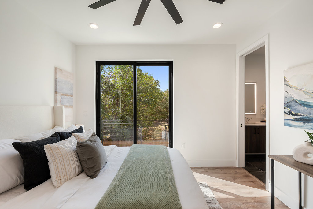 4407 Merle Drive, Unit B Austin, TX 78745 - Photo 20 of 38 a bed room with a bed and a large window