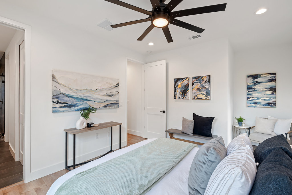 4407 Merle Drive, Unit B Austin, TX 78745 - Photo 21 of 38 a bedroom with a bed and a chandelier