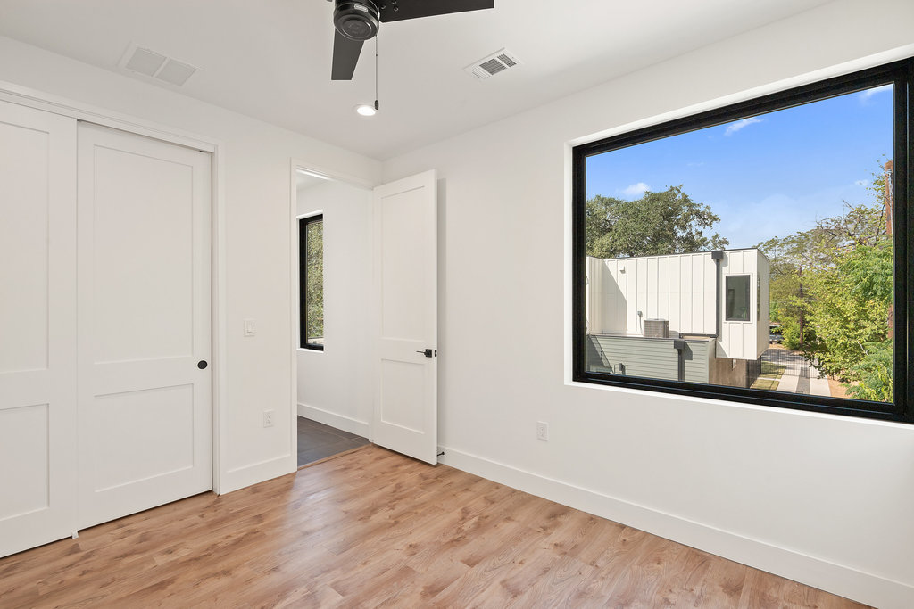4407 Merle Drive, Unit B Austin, TX 78745 - Photo 28 of 38 a view of an empty room with wooden floor and a window
