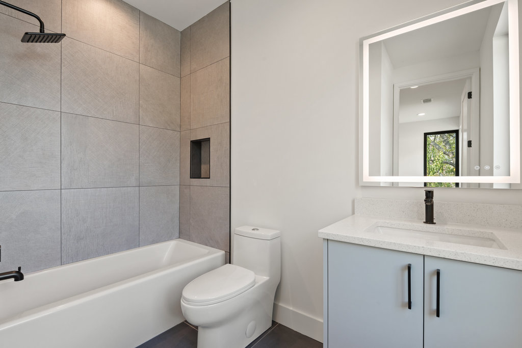 4407 Merle Drive, Unit B Austin, TX 78745 - Photo 29 of 38 a bathroom with a granite countertop sink toilet and shower