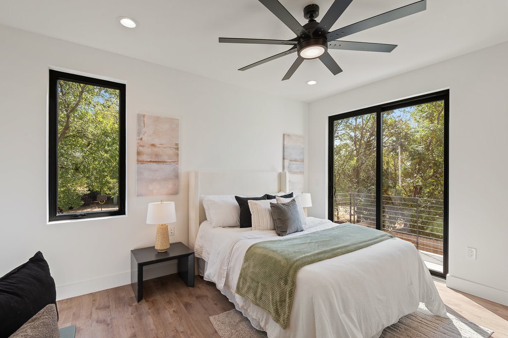 4407 Merle Drive, Unit B Austin, TX 78745 - Photo 4 of 38 a bedroom with a large bed and a large window