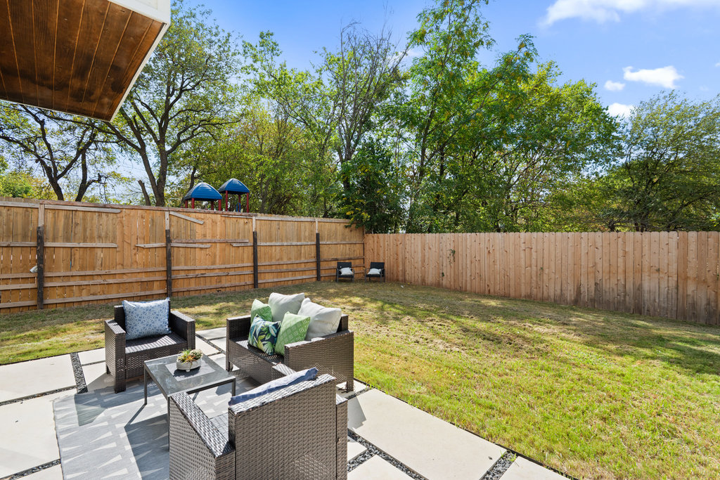 4407 Merle Drive, Unit B Austin, TX 78745 - Photo 5 of 38 a view of a backyard with chairs potted plants and wooden fence