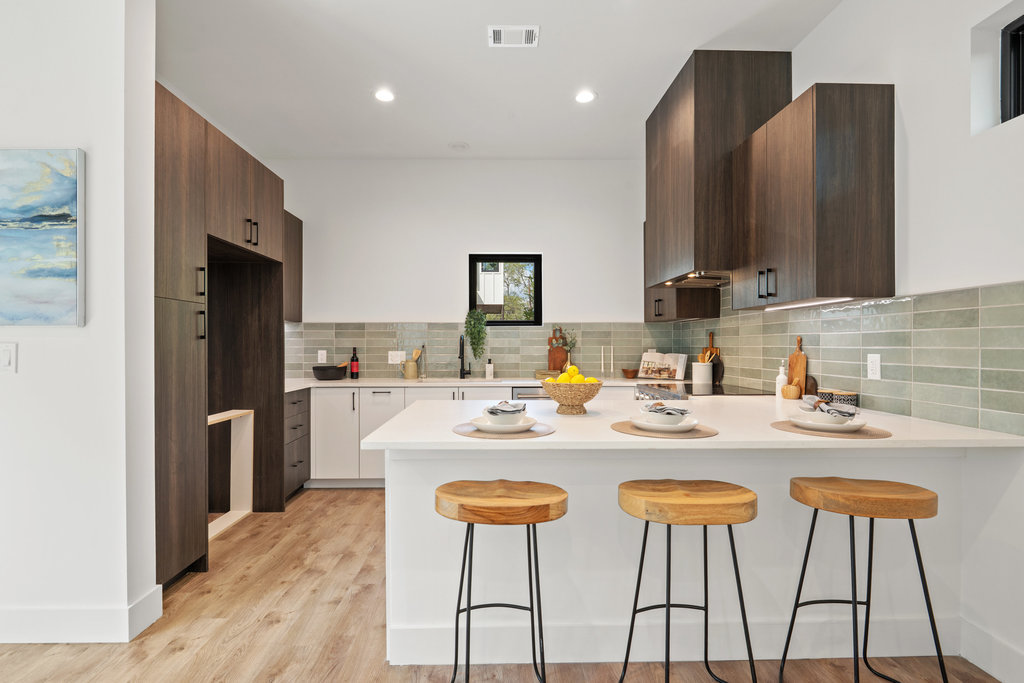 4407 Merle Drive, Unit B Austin, TX 78745 - Photo 6 of 38 a kitchen with stainless steel appliances kitchen island granite countertop a refrigerator a stove a sink and chairs with wooden floor