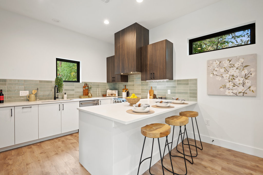 4407 Merle Drive, Unit B Austin, TX 78745 - Photo 7 of 38 a kitchen with a sink cabinets and wooden floor