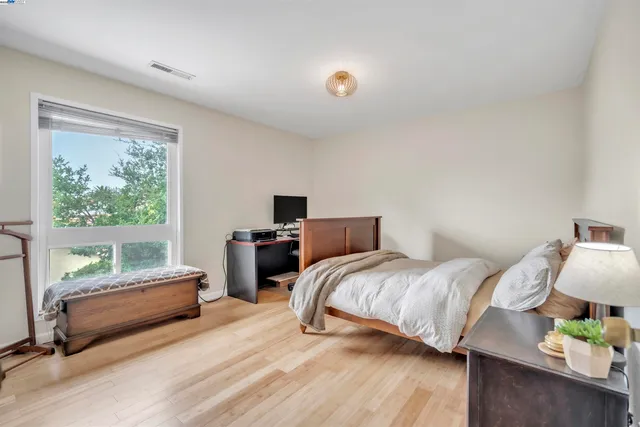 a bedroom with a bed and a couch