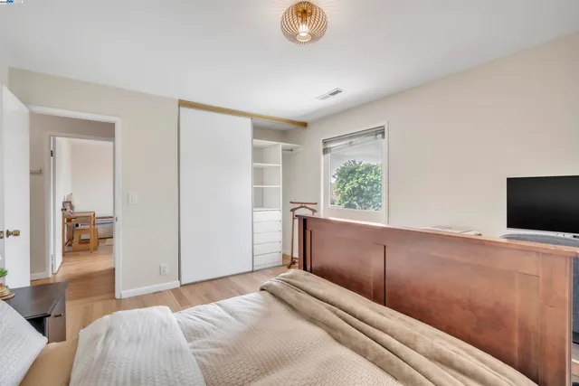 a bedroom with a bed and a television