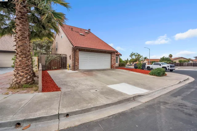 a backyard of a house with flower plants